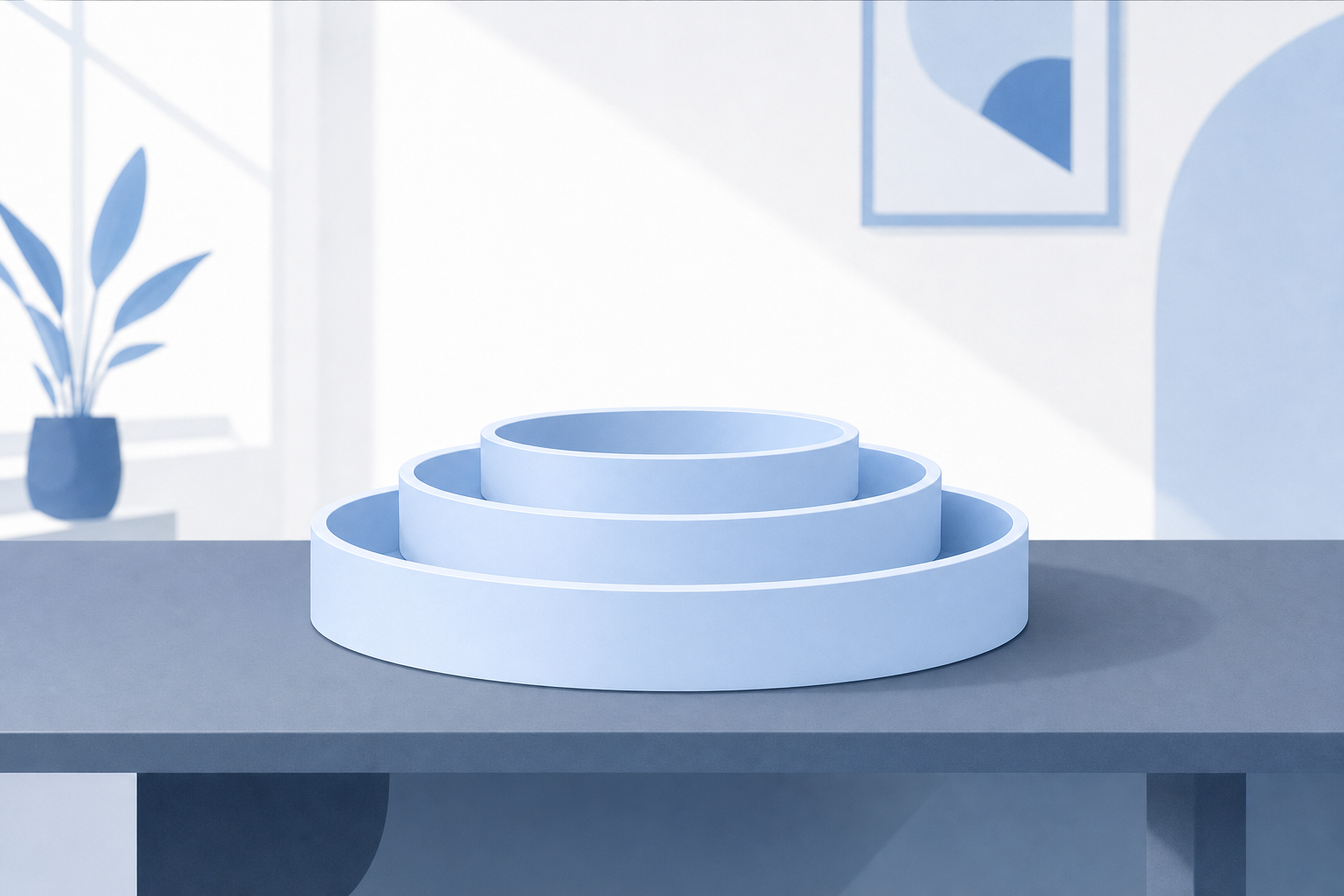 Three empty nested ice-blue rings resting on a mineral-grey table in a white room