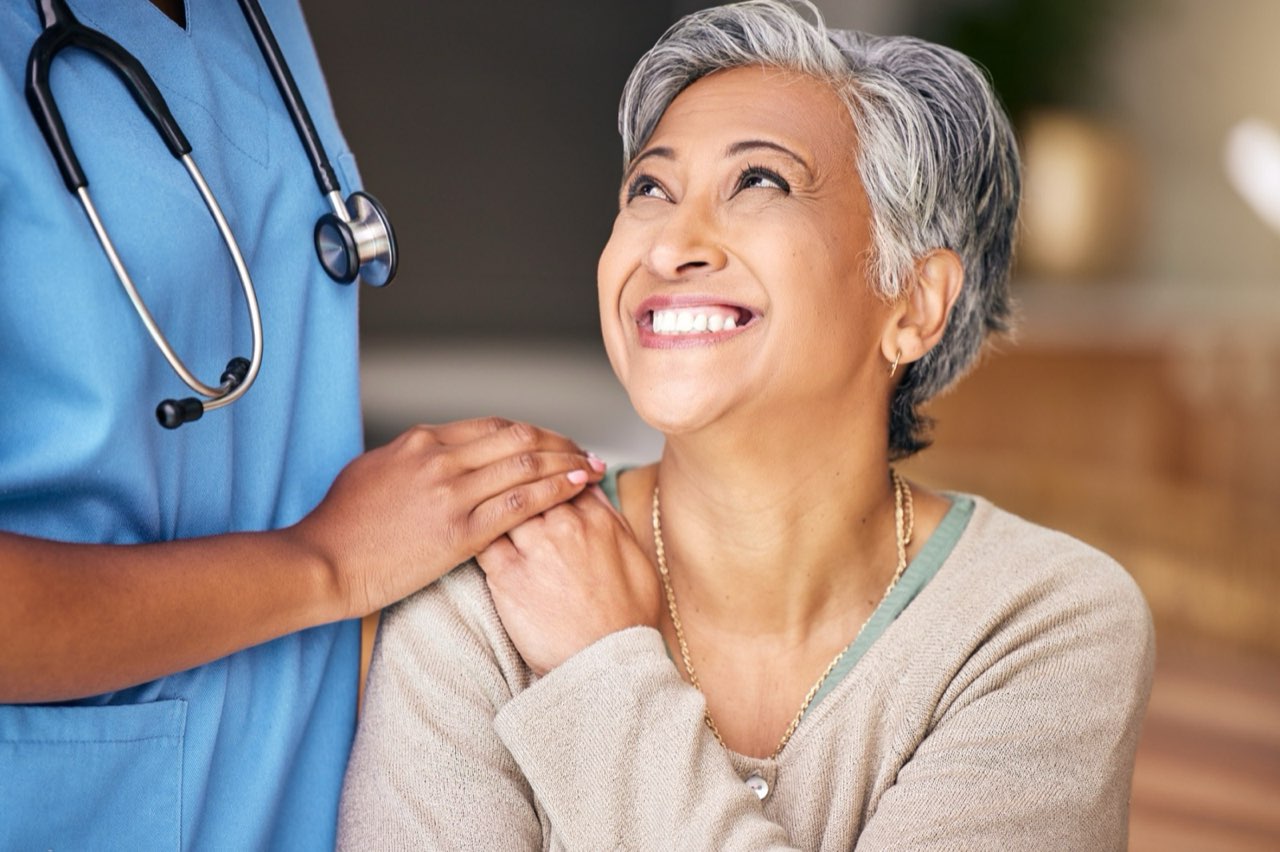 Smiling patient with her Vye provider during a caring consultation